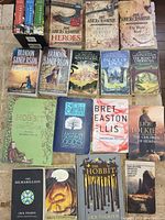 Books arranged showing covers with authors and titles visible including Tolkien, Abercrombie, Sanderson, Gaiman, and Ellis.