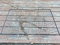 Top-down view of two gray metal wire baskets placed side by side, showing wire grid construction and handles on the longer sides