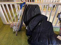 Two tennis racquets and two Homedics black chair massagers placed on the floor.