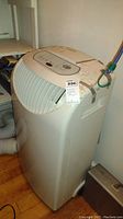 Full front and top view showing the control panel and vent slats of the Maytag portable air conditioner with attached exhaust hose and visible wear.
