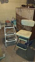 Photo of vintage folding stepladder and kitchen stool in basement setting