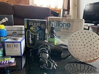 Photo showing assorted boxed and loose bathroom fixtures along with hairdryer and Axe air freshener sprays