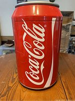 Front view of the Coca-Cola mini fridge shaped like a red soda can with white Coca-Cola logo.