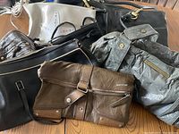 Seven assorted ladies handbags including two Matt & Nat and one Guess bag.