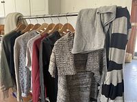 Photo of assorted ladies sweaters on a clothing rack showing variety in colors, knits and styles.