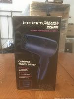 Boxed Conair Infiniti Premier compact travel hair dryer, black and dark blue, model 1875 watts, folding handle, new in box.