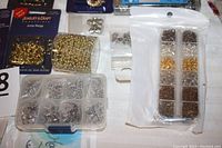 Gold-tone jump rings in Jewelry & Craft package and loose silver rings in compartment box