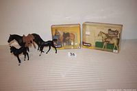 Five model horses displayed, two in original Breyer boxes and three loose figures including Gambler with saddle and Buck without Hillary.