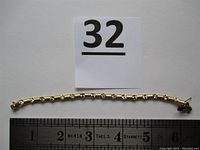 Full-length top-down view of bracelet against ruler showing overall design and length