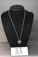 Front view of necklace on display bust showing full length chain and double heart pendant.