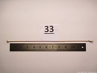 Full chain laid against white background with ruler