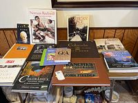 Wide view of all thirteen books arranged on a table showing variety of topics including Colorado, National Parks, and Americana.