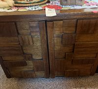 Front view of cabinet showing two doors with geometric raised block pattern