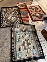 Four southwestern style rugs grouped on floor