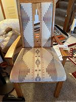 Front view of southwestern style arm chair showing seat and armrests with patterned upholstery.