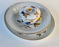 Photo showing all three pieces together: two serving bowls stacked and the small lidded casserole on top