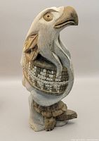 Overall front view of the indigenous stone eagle sculpture on a plain background.