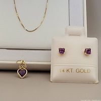 Chain displayed inside white Kohl’s box with pendant and earrings on display card