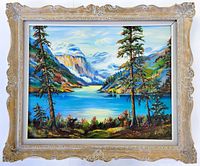 Full view of the large oil painting inside an ornate vintage carved wood frame showing the landscape of Lake Louise with vibrant colors.