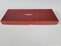 Top view of closed textured brown case with 'The Econasign' label centered on top.