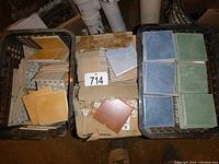 Overhead view of two baskets and a box containing ceramic tiles in beige, blue, green and brown pastel colors.