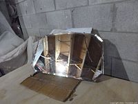 Photo showing mirror angled against a wall, displaying the beveled edges and reflective surface.