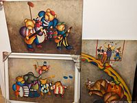 Photo showing three paintings: two stacked, one adjacent. Depicts bears with instruments and clowns with circus elephant.