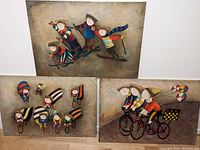 Overview of all three paintings leaning against a wall