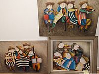 Wall display showing three paintings together