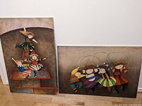 Both paintings side by side on the floor