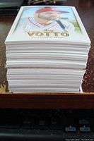 Stack of approximately 100 baseball cards featuring Joey Votto on top