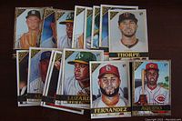 Photo of multiple baseball rookie cards laid out showing different player portraits and team logos