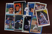 Photo of Nolan Ryan baseball cards spread out showing various poses and teams including Texas Rangers and Houston Astros.