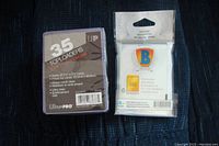 Clear image showing the pack of 35 Ultra PRO top loaders alongside a pack of 100 Ultra PRO soft sleeves, both sealed and new.