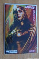 Photo of the comic book front cover showing Wonder Woman in golden armor from the Future State Dark Detective series, Batman Wonder Woman 84 variant.