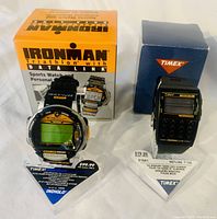 Front view showing the Ironman Triathlon Data Link watch and Timex calculator watch with their original boxes