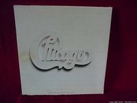 Front cover of one Chicago album showing white cover with embossed Chicago logo