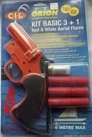 Original packaged Orion Kit Basic 3+1 flare kit showing red flare launcher pistol, 3 red twin star aerial flare cartridges, and 1 white instructor cartridge.