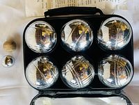 Chrome-plated steel boules (6), wooden/chrome target ball, all stored inside black zippered carrying case on white background.