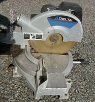 Front angle view of Delta 10" compound miter saw showing the blade, base, and angle adjustments.