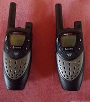 Front view of the pair of Cobra MicroTALK walkie talkies showing the screen, buttons, and antenna.