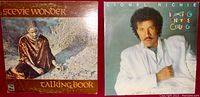 Both vinyl album covers side by side: Stevie Wonder's "Talking Book" on left and Lionel Richie's "Dancing on the Ceiling" on right.
