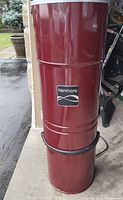 Front view of the Kenmore Sears Central Vacuum with red cylindrical canister and logo.
