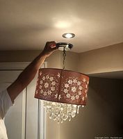 Light fixture hanging from ceiling, showing overall size and light effect.