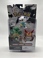 Front view of 3 Pokémon figures in original packaging showing Oshawott, Pansage, and Dartrix.