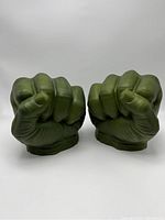 Front view of the two green foam Hulk fists, showing clenched knuckle details.