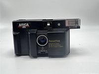 Front view of Aryca 35 camera showing built-in flash, fixed lens, and branding.