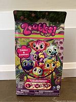 Front view of Zoobles packaging showing colorful characters and product details.