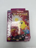 Front of Ms. Pac-Man game box for Sega Game Gear wrapped in plastic showing colorful artwork and branding.