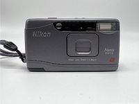 Front view of Nikon Nuvis Mini I camera showing lens, flash, and lens branding.